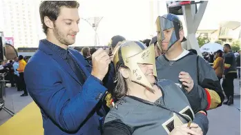  ?? BRUCE BENNETT/GETTY IMAGES ?? Vegas Golden Knights fans came decked out in team gear to see Colin Miller and the team’s other players walk a golden carpet before the team’s home opener against the Arizona Coyotes.