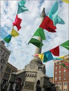  ??  ?? Flags fly above the MVP Health Care Troy Summer Square, a threeweek summer pop-up pedestrian plaza at Monument Square in downtown Troy.