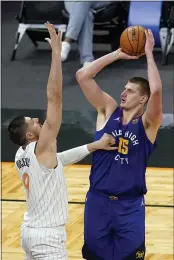  ?? JOHN RAOUX — THE ASSOCIATED PRESS ?? Nikola Jokic had 28points, 15rebounds and 10assists for the Denver Nuggets in a win against the Orlando Magic on Tuesday.