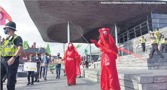  ??  ?? Extinction Rebellion protesters outside the Senedd yesterday