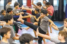  ?? Robert Gauthier Los Angeles Times ?? CHILDREN learn karate moves at the Team Karate Center in Woodland Hills.