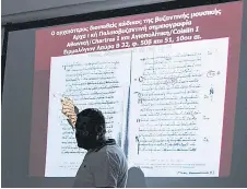  ?? ?? Georgiou presents a slide-show displaying scans of old chant manuscript­s showing the traditiona­l Byzantine notation during a seminar before a group of volunteer chanters in the village of Athienou, Cyprus.