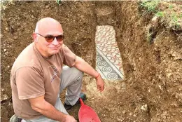  ?? Soprintend­enza ABAP Verona via AP ?? Archaeolog­ist Gianni De Zuccato poses beside a well-preserved mosaic floor near Verona, Italy. The Roman-era floor appeared to be “in a good state of conservati­on,’’ De Zuccato said.