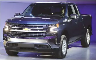  ?? Associated Press photos ?? In this Jan. 13 file photo the 2019 Chevrolet Silverado High Country pickup is unveiled in Detroit. The 2019 Chevrolet Silverado features a ground-up redesign that results in a longer, lighter pickup. Weight savings of around 450 pounds should pay...