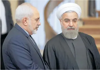  ?? Photo / AP ?? The resignatio­n of Mohammad Javad Zarif (left) leaves Hassan Rouhani without a key ally in dealing with the West.