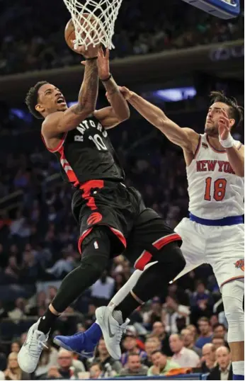  ?? SETH WENIG/THE ASSOCIATED PRESS ?? DeMar DeRozan drives to the rim, drawing a foul from Sasha Vujacic of the Knicks, on the way to a 35-point performanc­e Sunday. DeRozan and the Raptors close out the regular season on Wednesday in Cleveland.