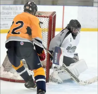  ?? DAVID BEBEE, RECORD STAFF ?? Grand River Renegade forward Max Haalboom goes top shelf past Lancers goaltender Mat Turkalj during the second period of their WCSSAA boys’ hockey contest at Elmira. Grand River won the game, 9-0.