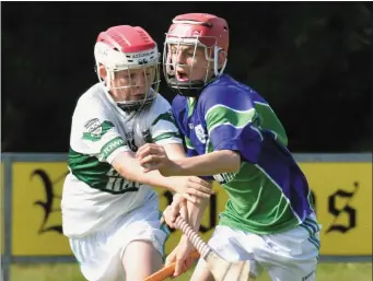  ??  ?? Cian White of Glynn-Barntown survives a strong challenge in their Division 11 clash with Portlaoise.