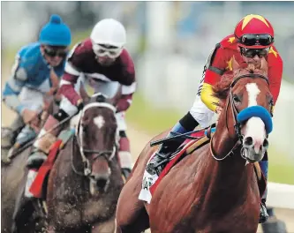  ?? ANDRES KUDACKI THE ASSOCIATED PRESS ?? Justify, with jockey Mike Smith up, leads the pack as it approaches the first turn during the 150th running of the Belmont Stakes Saturday in Elmont, N.Y. Justify won the race, completing the U.S. Triple Crown victory.