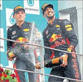  ??  ?? Max Verstappen (left) sprays champagne on Red Bull teammate and third placed Daniel Ricciardo.