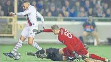  ??  ?? PSG'S Kylian Mbappe (left) scores as Brugge goalkeeper Simon Mignolet makes a futile attempt in their match on Tuesday.
