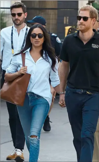  ??  ?? STRAINS: The Sussexes with their PR supremo Jason Knauf