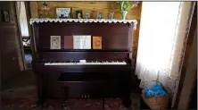  ?? NWA Democrat-Gazette/LAURINDA JOENKS ?? The piano of Carrie Cash (Johnny’s mother) sits prominentl­y in the living room at Dyess. “We’d gather around mother’s old upright piano,” said Joanne Cash Yates, Johnny’s sister, in the book A New Deal in Dyess. “Mama played the piano. She didn’t know...