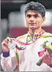  ?? REUTERS; AP ?? Krishna Nagar (left) during the badminton men’s singles; Suhas L Yathiraj after receiving a silver medal for men’s singles badminton, in Tokyo.