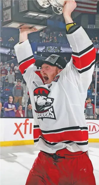  ?? AHL PHOTO ?? Patrick Brown, then with the Charlotte Checkers, lifts the Calder Cup in June after a contentiou­s series that included him hitting the Wolves’ Keegan Kolesar from behind in Game 2 and setting off a brawl.