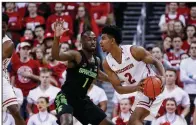  ?? AP/ANDY MANIS ?? Michigan State’s Joshua Langford (1) scores two of his five points in the Spartans’ 68-63 victory over Wisconsin on Sunday in Madison, Wis. The victory allowed the Spartans to win the Big Ten outright.