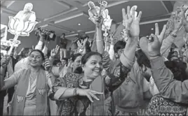  ?? SATISH BATE/HT PHOTO ?? BJP supporters celebrate at the party office in Ahmedabad on Monday.