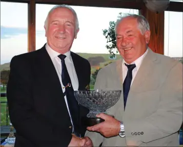  ??  ?? Wicklow Golf Club President Moses Coffey presents Larry O’Grady, winner of the President’s Prize, with his award.