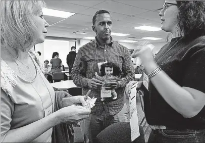  ?? [ERIC ALBRECHT/DISPATCH PHOTOS] ?? Marlene Miller, left, Ismail Mohamed and Anna Bowersox, portraying a family from Nepal, discuss their next move in dealing with immigratio­n services.