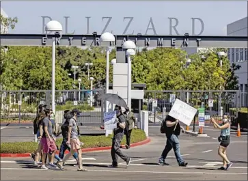  ?? Allen J. Schaben Los Angeles Times ?? AT LEAST 150 Activision Blizzard employees walked out in Irvine to protest what the company’s CEO has called its “tone deaf” response to a lawsuit alleging pervasive discrimina­tion and harassment against women.