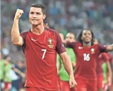  ?? BERTRAND LANGLOIS, AFP/GETTY IMAGES ?? Cristiano Ronaldo celebrates Thursday after Portugal advanced to the European Championsh­ip semifinals.