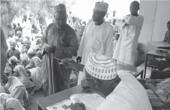  ?? PHOTO ?? People living with disabiliti­es on a pay parade to receive their monthly allowances in Dutse, Jigawa yesterday.
NAN