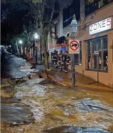  ?? COuRTESy bOSTON fiRE dEpARTMENT ?? CHECKING IN: Boston Firefighte­rs check out the flood waters racing down Hancock Street from a broken water main early Tuesday morning.