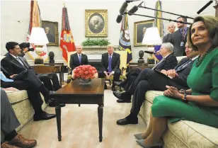  ?? Alex Wong / Bloomberg ?? President Trump (center right) meets with congressio­nal leaders and Vice President Mike Pence last week, revealing a deal with Democrats.