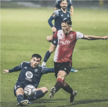  ??  ?? DRENCHED: Town’s Billy Chadwick lunges for the ball in Tuesday night’s 1-0 win over Woking. Photo: Marcus Branston.