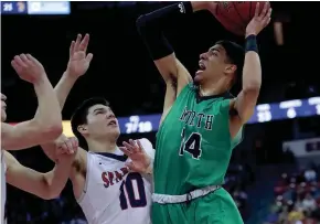  ?? RICK WOOD / MILWAUKEE JOURNAL SENTINEL ?? Oshkosh North’s Tyrese Haliburton’s drives to the basket, but his shot is slapped away by Brookfield East’s Patrick Cartier.