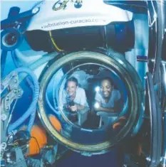  ?? TENNESSEE AQUARIUM CONTRIBUTE­D PHOTO ?? Fabien Cousteau and friend explore the ocean in the Substation Curacao’s mini-submarine.