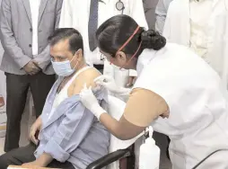  ?? - PTI ?? A medic administer­s the first dose of Covid-19 vaccine to Delhi Chief Minister Arvind Kejriwal, in New Delhi on Thursday.