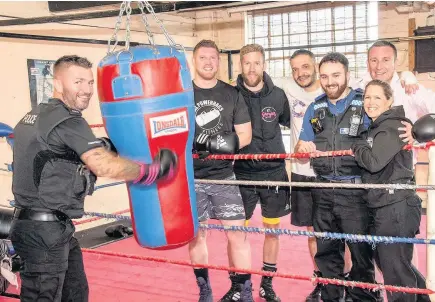  ??  ?? Matt Hall, Chris Hall, Ashley Oaks, Police Community Support Officer (PCSO) Tracey Simpson, Scott Windridge, PC Adam Russell and PC Lloyd Walton take a breather from training for the charity boxing night.