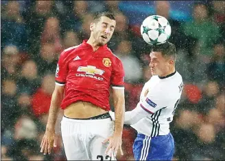  ??  ?? Manchester United’s Henrikh Mkhitaryan (left), is airborne with Basel’s Taulant Xhaka during the Champions League Group A soccer match between Manchester United and Basel, at the Old Trafford Stadium in Manchester
on Sept 12. (AP)