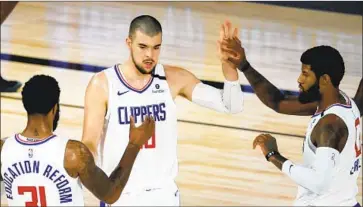  ?? Kevin C. Cox Associated Press ?? THE CLIPPERS’ I VICA ZUBAC, center, thinks new coach and former assistant Tyronn Lue is a perfect f it.
