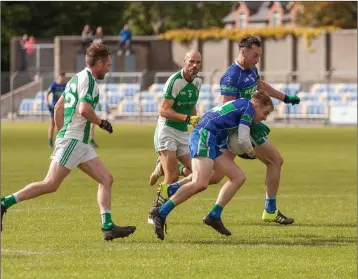  ??  ?? AGB’s Daire McBride drives into the heart of the Avondale defence with Cormac Hyland alongside.