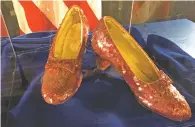  ?? JEFF BAENEN/ASSOCIATED PRESS ?? A pair of ruby slippers worn by actress Judy Garland in the The Wizard of Oz are displayed Tuesday in Brooklyn Center, Minn. Authoritie­s announced that the slippers, stolen in 2005 from the Judy Garland Museum in Grand Rapids, Minn., were recovered in a sting operation.