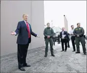  ?? K.C. Alfred San Diego Union-Tribune ?? PRESIDENT TRUMP checks out border wall prototypes near the Otay Mesa Port of Entry last month.