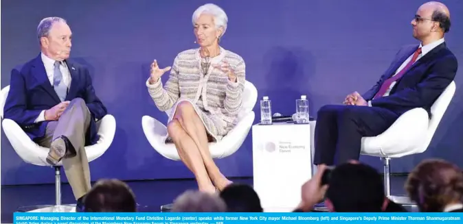  ??  ?? SINGAPORE: Managing Director of the Internatio­nal Monetary Fund Christine Lagarde (center) speaks while former New York City mayor Michael Bloomberg (left) and Singapore’s Deputy Prime Minister Tharman Shanmugara­tnam (right) listen during a panel discussion at the Bloomberg New Economy Forum in Singapore yesterday. — AFP