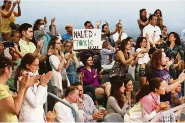  ?? Wilfredo Lee / Associated Press ?? Demonstrat­ors cheer at a city commission meeting last week in Miami Beach, Fla., to protest the aerial spraying of the pesticide naled, which is used to kill adult mosquitoes that may be carrying the Zika virus. Opponents question the safety and...