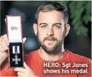  ??  ?? HERO: Sgt Jones shows his medal