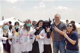  ??  ?? dr Marc sinclair with volunteers and razan al najjar (third from left) in Palestine.