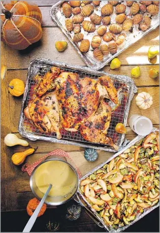  ?? Photograph­s by Kirk McKoy Los Angeles Times ?? BAKE IN SHEET PANS, an all-purpose approach to a less-fuss, tasty meal with, from top, Hasselback potatoes, herb-roasted spatchcock­ed turkey and roasted Brussels sprouts with pears.