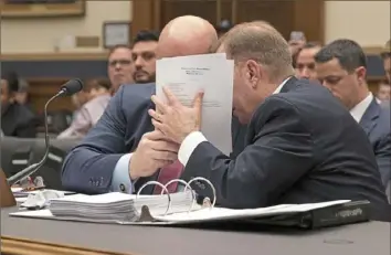  ?? Chip Somodevill­a/Getty Images ?? Acting U.S. Attorney General Matthew Whitaker, left, consults with a staff member while testifying Friday before the House Judiciary Committee in the Rayburn House Office Building on Capitol Hill in Washington.