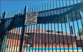  ?? (AP/Claire Savage) ?? The empty pool at the Hamlin Park Pool remains closed to swimmers June 16 in Chicago. Chicago’s public pools will remain closed until July 5, according to park superinten­dent and CEO Rosa Escareno.