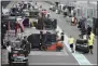  ?? MICHAEL DODGE ?? Workers pack up in pit lane after the cancellati­on of the Australian Formula One Grand Prix in Melbourne, Friday, March 13, 2020. The first F1 Grand Prix of the season was canceled two hours before the first official practice was set to start Friday after organizers relented to pressure to call it off amid the spreading coronaviru­s.