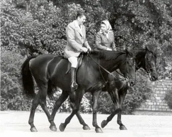  ??  ?? The Queen and President Ronald Reagan go riding in Windsor in 1982