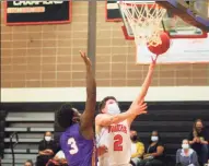  ?? Christian Abraham / Hearst Connecticu­t Media ?? Ridgefield’s Matthew Knachel (2) lays up the ball as Westhill’s Omari Lewis (3) defends during the FCIAC boys basketball championsh­ip in Ridgefield on Friday.