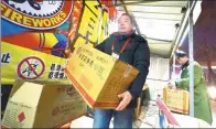  ?? GUO QIAN / FOR CHINA DAILY ?? A fireworks stall owner withdraws his products in eastern Beijing’s Sihui area on Feb 1, the last day of the capital’s sales period for fireworks and firecracke­rs.