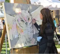  ??  ?? Amy Ringholz works on a painting of an owl during the 2018 Quickdraw event.